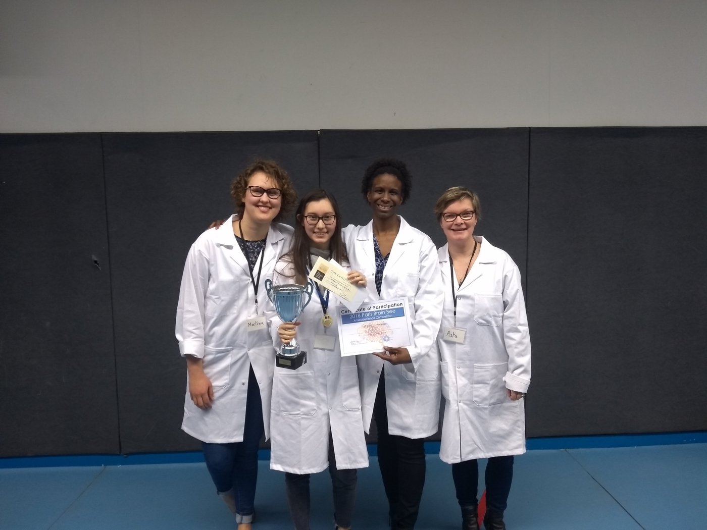 With colleagues receiving an award, in lab coats