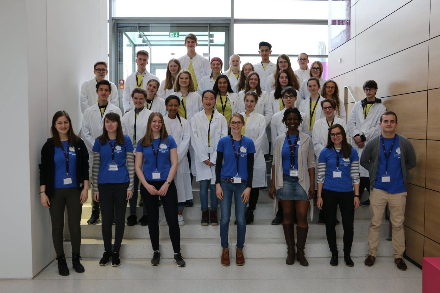 Outreach volunteers in lab coats