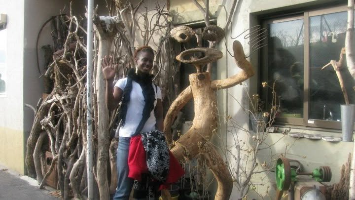 Beside a driftwood sculpture